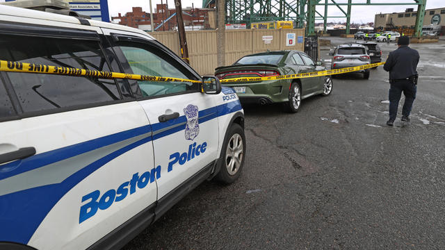 A Boston Police officer tapes off a crime scene on March 28, 2023. 