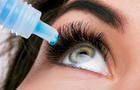 Close-Up Of Woman Putting Drip In Eye 